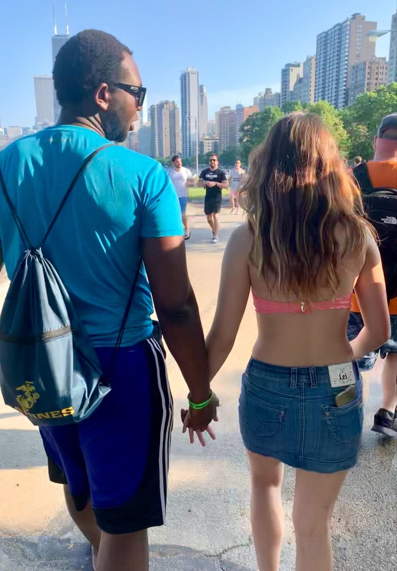 Abdel and Emily walking hand-in-hand in Chicago